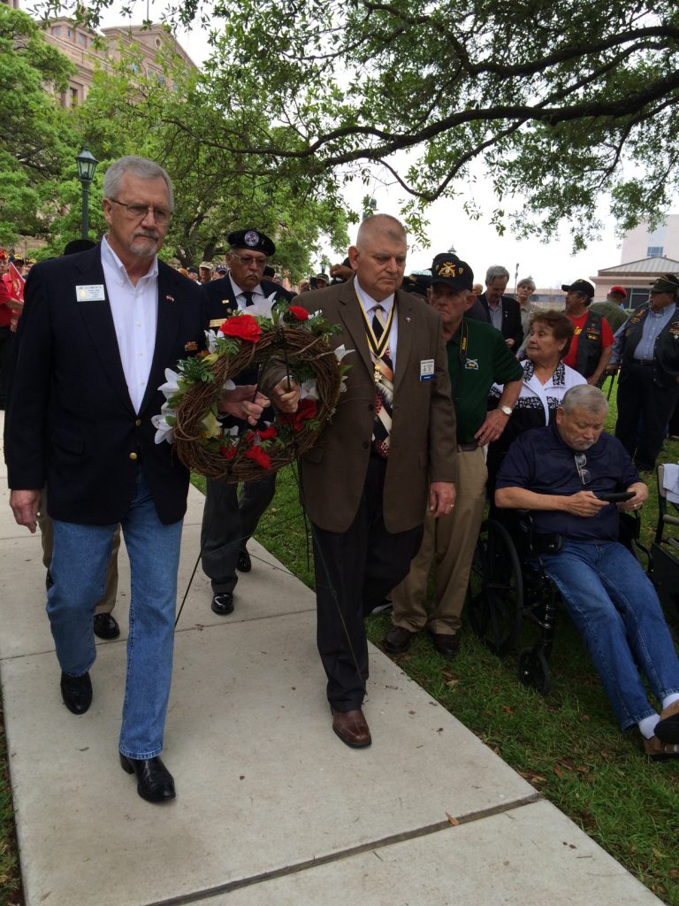 President Courreges presenting wreath
